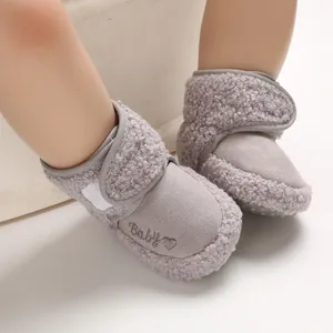 Close-up of grey plush winter baby snow boots with soft soles for pre-walkers