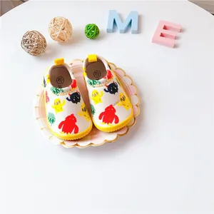 Detailed view of children's canvas slip-on shoes featuring vibrant cartoon monster prints