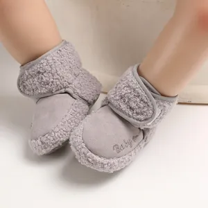 Detail view of grey soft-sole baby snow boots with plush lining and velcro closure