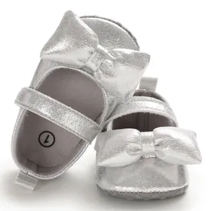 Detailed view of silver baby girl princess shoes with large bow and soft anti-slip sole
