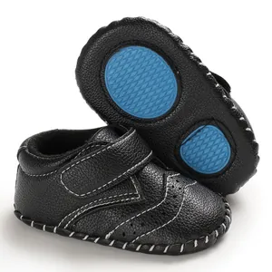 Detailed view of black baby walker shoes with blue anti-slip rubber sole for infants
