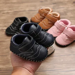 Detailed view of navy blue baby walking shoe with contrast stitching and velcro strap