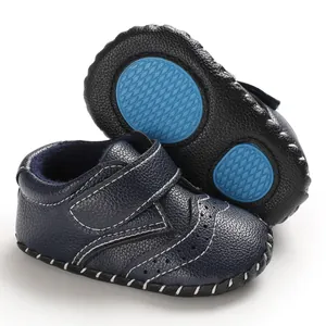 Detail view of navy blue baby walking shoes with anti-slip rubber sole and white stitching