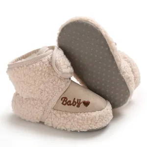 Close-up of beige baby snow boots featuring soft fleece material and non-slip soles.