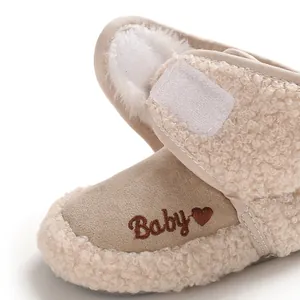 Detail showing the soft sherpa lining and 'Baby' embroidery on the winter bootie