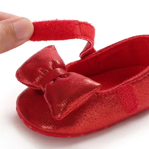 Close-up of red shimmering baby princess shoe showing velcro strap detail