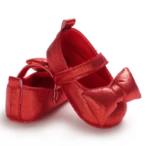 Shiny red baby girl Mary Jane shoes with soft sole and bow detail for first steps.