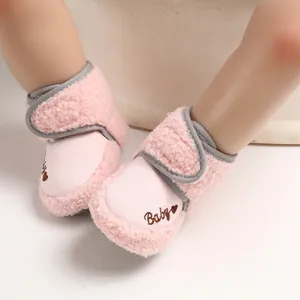 Detailed close-up of pink Sherpa baby walker shoes with soft sole and velcro strap