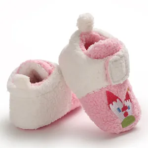 Soft plush baby walking shoes with cute cartoon castle embroidery for winter months.