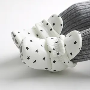 Macro close-up detail of infant soft sole walker shoes with black star pattern print