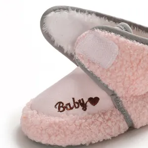 Close-up of pink baby winter boot showing 'Baby' heart embroidery and soft fleece