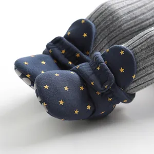 Close-up of baby star-patterned sock shoes with non-slip soles and ribbed cuffs