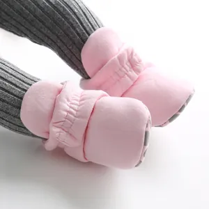 Soft pink baby walking shoes with warm cotton material and non-slip textured soles