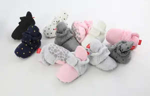 Collection of soft cotton infant booties in various colors and patterns with anti-slip soles.