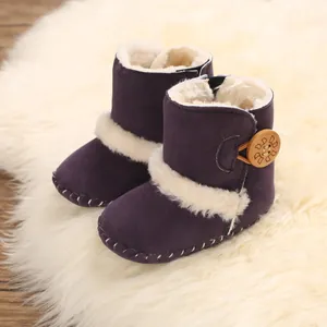 Detailed view of purple baby snow boots with soft faux fur lining and wooden button