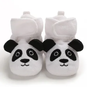 Dettaglio di scarpine da neonato a forma di panda in peluche con suola molto morbida.