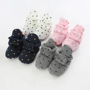 Soft-soled infant booties with decorative star patterns in white, pink, navy, and grey colors.
