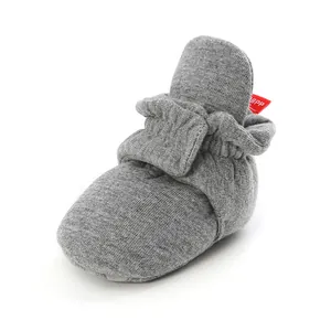 Close-up of grey knit infant walking shoes showing soft fabric texture and elastic ankle