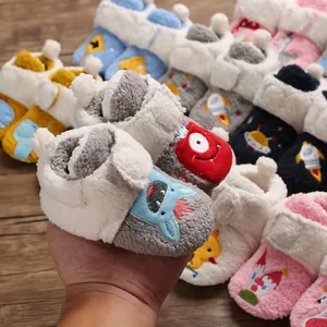 Detailed view of plush baby winter walker shoes with colorful cartoon embroidery.