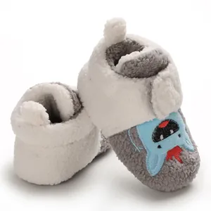 Detail view of soft fleece-lined baby walking shoes featuring cute blue monster embroidery