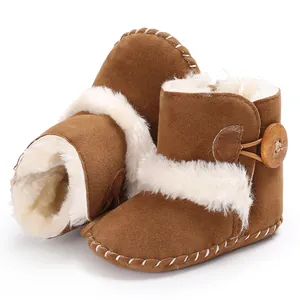 Close-up of brown baby snow boots with fluffy white fur lining and decorative wooden button