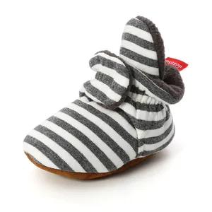 Detailed view of striped knitted baby bootie featuring soft and warm fleece lining