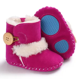 Detailed view of pink baby snow boots showing anti-slip blue rubber sole
