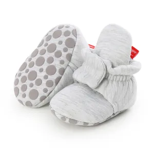 Detail view of grey baby booties with non-slip sole and soft knit cotton fabric