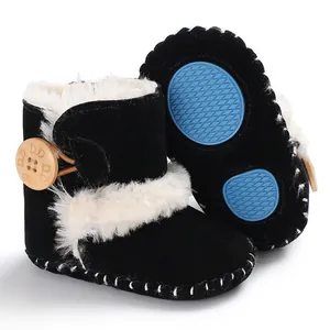 Close-up detail of infant winter snow boots featuring soft anti-slip soles and fur lining