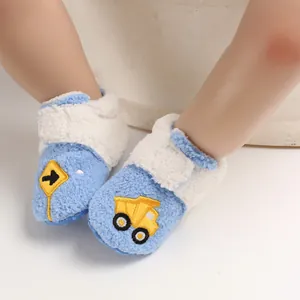 Detailed view of blue fleece baby winter shoes with cute cartoon truck embroidery
