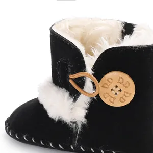 Close-up of warm baby snow boot with soft faux fur lining and wooden button