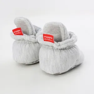 Detailed back view of gray soft-sole baby walking booties with red brand tags