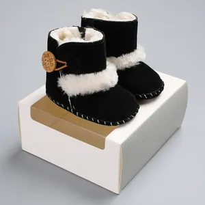 Close-up detail of black winter baby snow boots with warm white faux fur lining