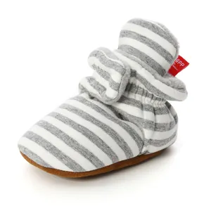 Detail view of striped knit baby bootie with warm plush lining and soft non-slip sole