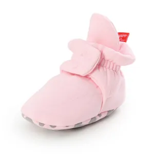 Detailed view of pink soft cotton baby sock shoes with non-slip soles and velcro strap