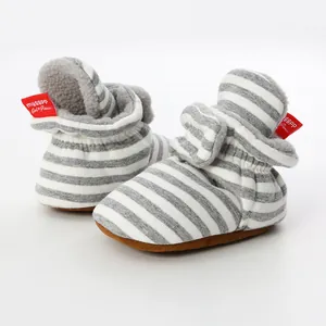 Macro view of grey and white striped baby booties showing warm fleece lining and soft sole