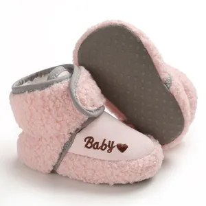 Pink fleece baby winter boots with non-slip soles and embroidered heart detail