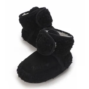 Detailed view of black baby snow boots with warm fleece lining and embroidered heart logo.