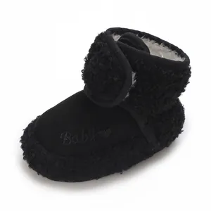 Close-up detail of black sherpa baby bootie with heart embroidery and soft fleece lining