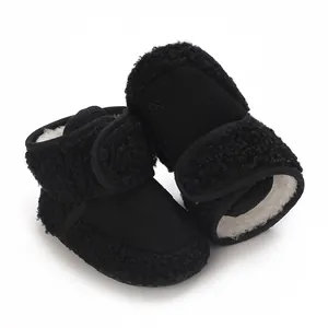 Close-up detail of black winter baby snow boots featuring plush fleece lining and soft soles