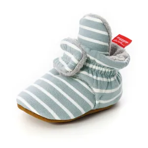 Detailed view of blue striped knit baby bootie with soft warm fleece lining