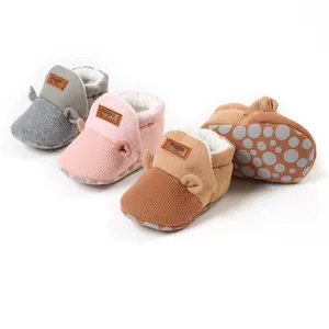 Detailed view of multi-color warm fleece-lined baby walking shoes with anti-slip dot soles