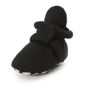Close-up detail of black infant soft sole walker shoe with elasticated ankle support