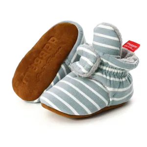Detailed close-up of striped knit baby bootees featuring soft soles and warm lining