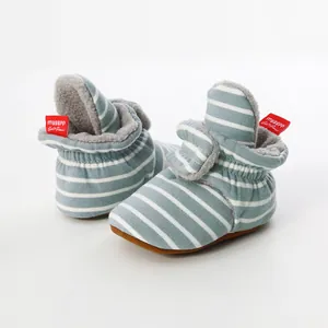 Detail of striped knit baby booties with soft fleece lining and non-slip soles