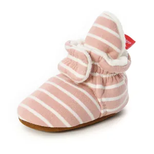 Detailed view of pink striped knit baby bootie with warm fleece lining and soft sole