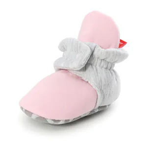 Detail view of pink and grey soft-soled baby walker shoe with adjustable ankle strap