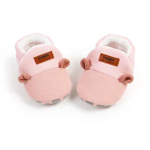Top view of pink plush baby winter shoes with cute ear details and warm fleece lining