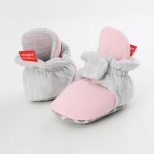 Detail showing soft fabric and pink-grey design of baby sock shoes