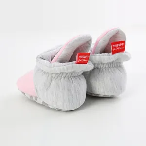 Detailed back view of soft pink and grey knit baby walking shoes with elastic ankles